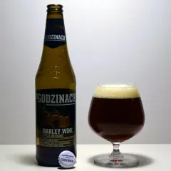 Butelka i kielich z ciemnym piwem typu barley wine. Etykieta informuje o edycji limitowanej.