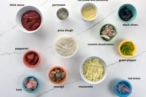 Składniki na pizzę: sos, ser, ciasto, pepperoni, szynka, kiełbasa, pieczarki, oliwki, papryka, cebula. Idealny farsz do pizzy!