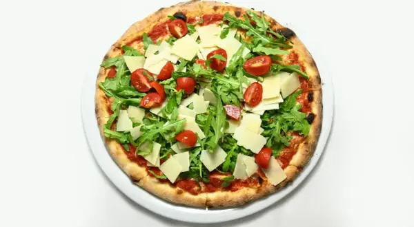 Pizza z rukolą i pomidorkami, z płatkami parmezanu. Świetna opcja, co zamiast sera na pizzy, gdy chcesz czegoś lżejszego.