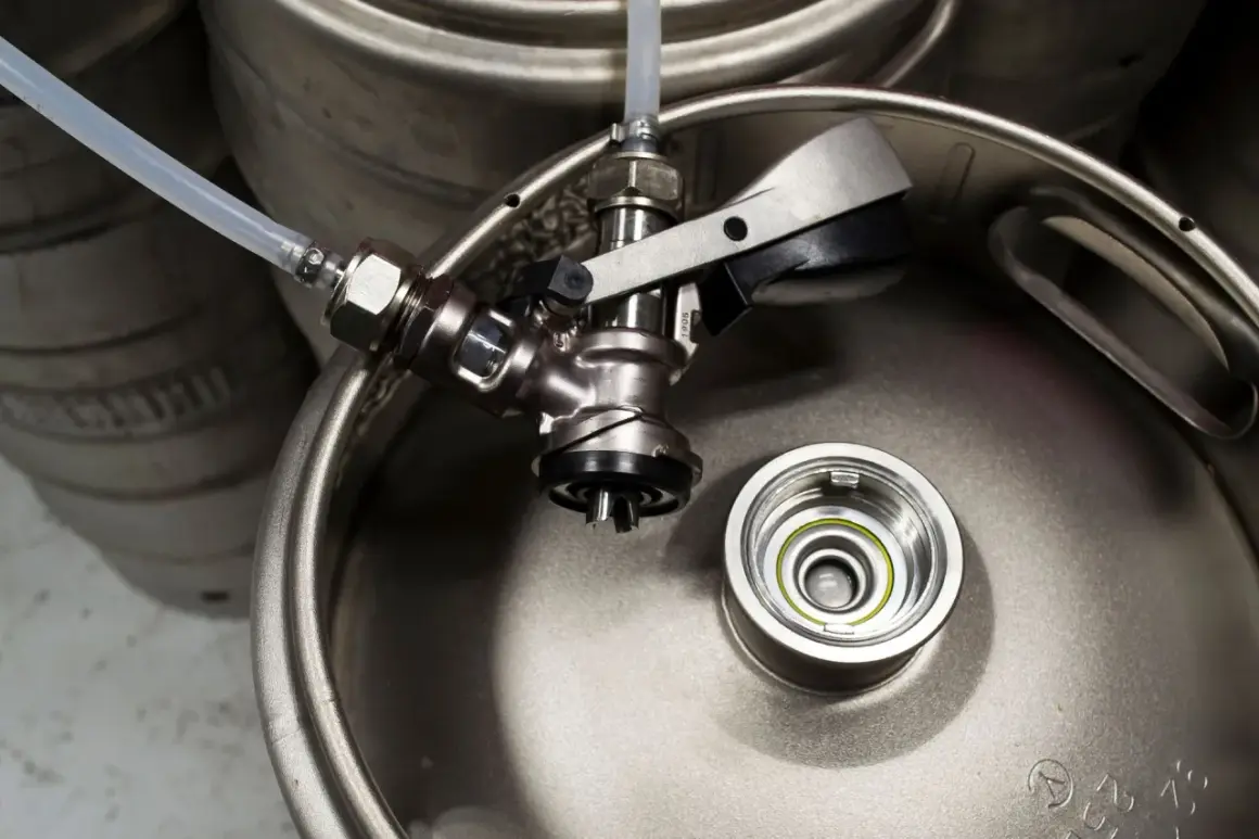 Metalowy piwo keg z podłączonym kranikiem i rurką. Gotowy do nalewania orzeźwiającego napoju.