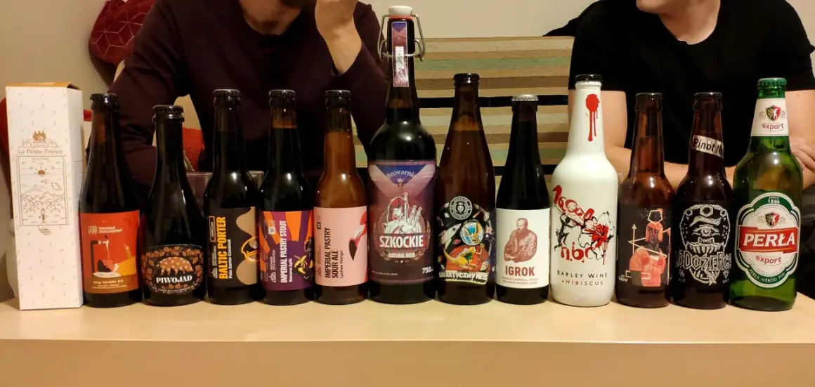 Rząd butelek z piwem, w tym mocne piwo, z etykietami "Piwojad", "Baltic Porter", "Imperial Pastry Stout", "Szkockie", "Igroki" i "Perła".